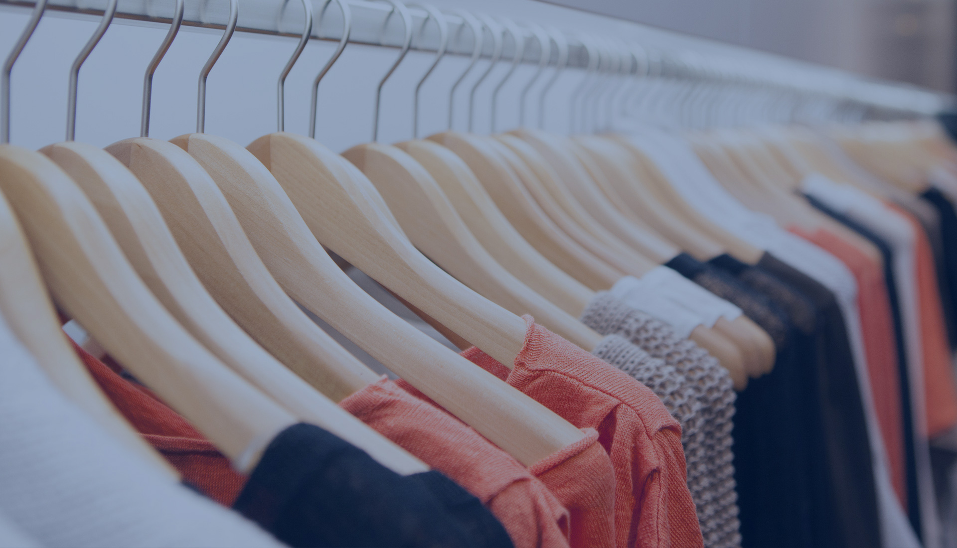 Photo of designer clothes on hangers