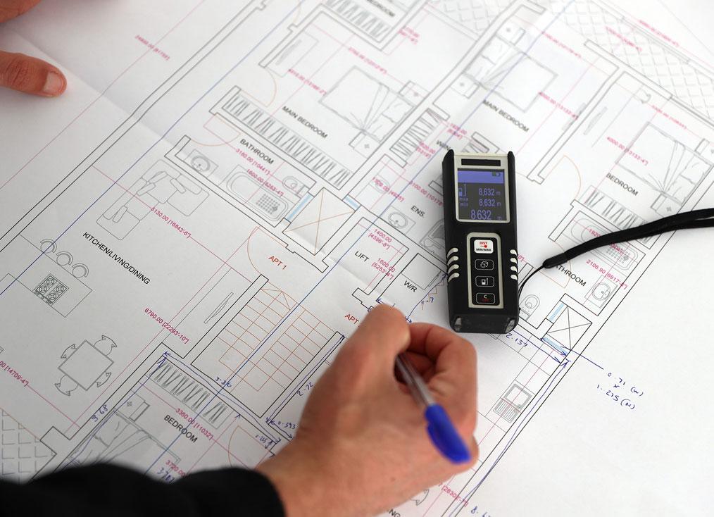 Photo of draughtsman surveying building plans