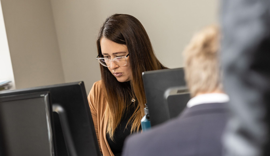 Photo of staff member looking at a laptop