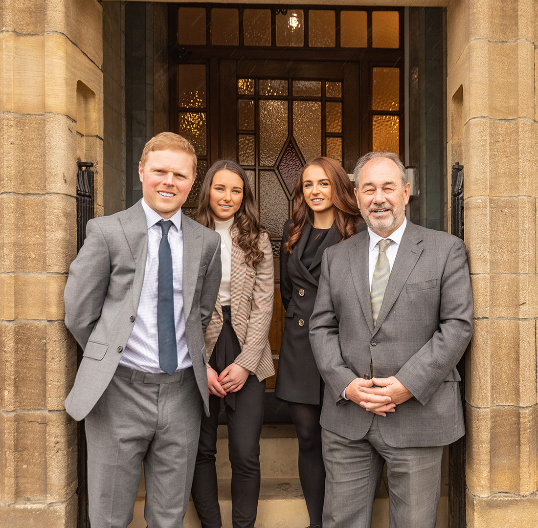 Members of staff in doorway of office