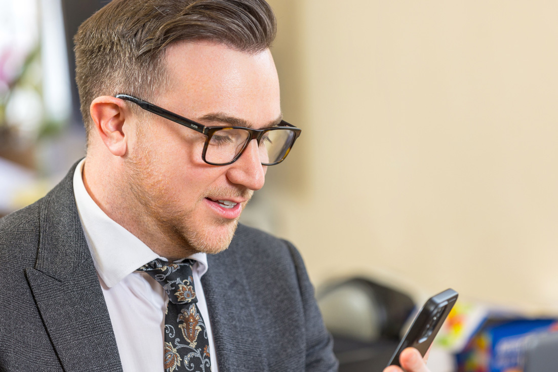 Photo of staff member looking at phone