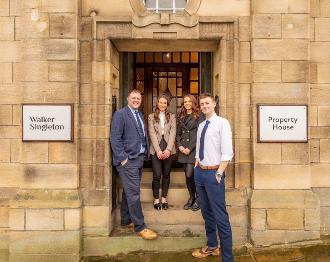 Members of staff outside the office